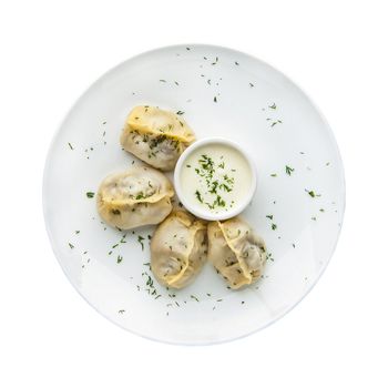 Manti in a plate on a white background. Top view. Isolated