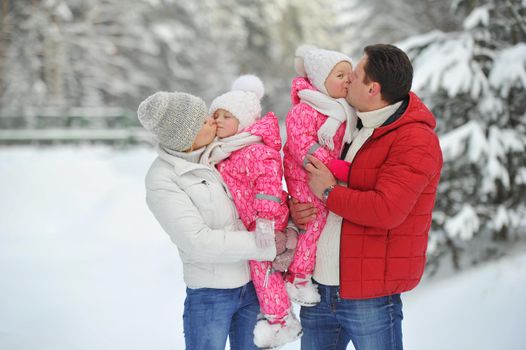 A large family with children on a walk in winter in the forest.