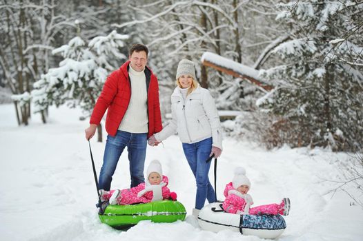 A large family with children on a walk in winter.