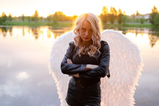 fallen angel. girl in black with white angel wings