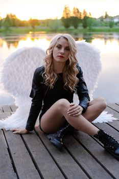 fallen angel. girl in black with white angel wings