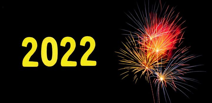 New Years card for 2022 with gold digits on a firework background.