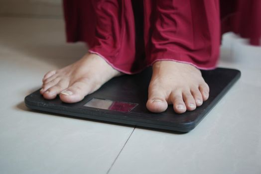 woman's feet on weight scale close up