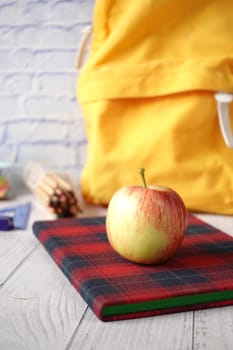 black to school concept with apple on notepad on table