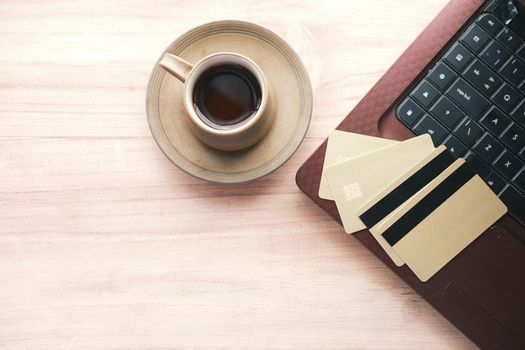 high angle view of credit cards on keyboard on orange background