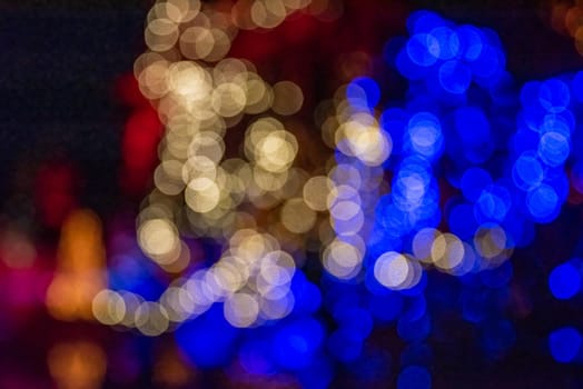 Colorful group of holiday lights on dark background of night