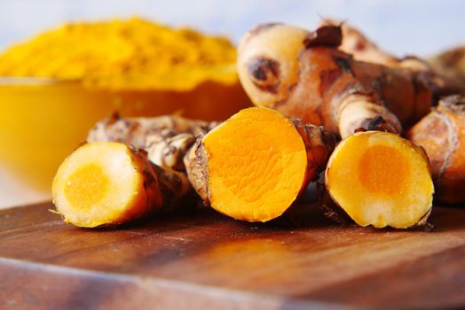 detail shot of turmeric root in bowl on table