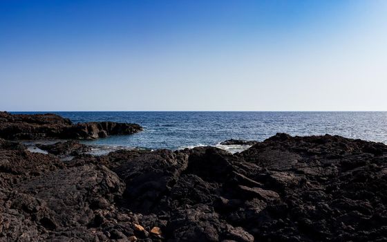 View of the scenic lava rock cliff in the Linosa island. Sicily