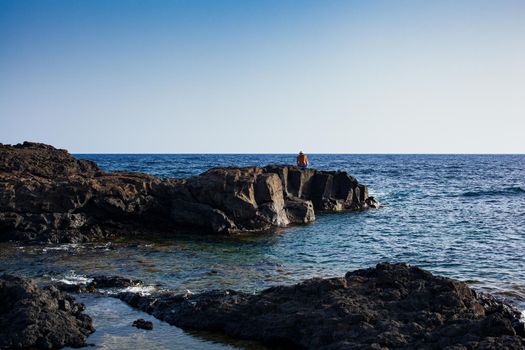 View of the scenic lava rock cliff in the Linosa island. Sicily