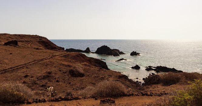 View of the scenic lava rock cliff in the Linosa island. Sicily