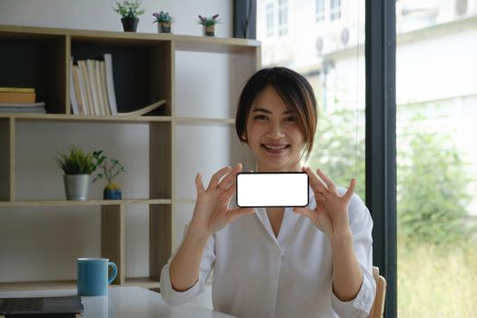 A Woman excited surprise and showing cell phone screen. Blank screen for your advertising