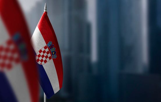 Small flags of Croatia on a blurry background of the city.