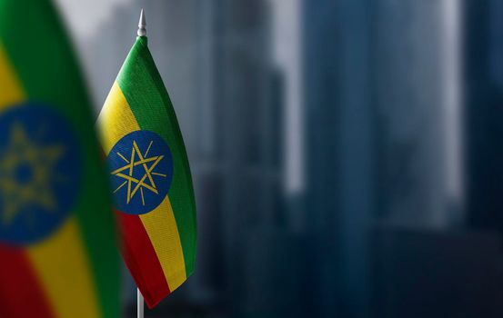 Small flags of Ethiopia on a blurry background of the city.