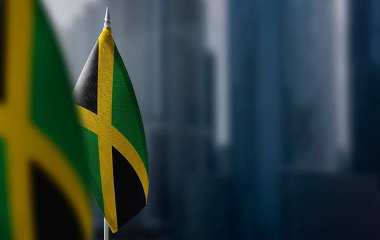 Small flags of Jamaica on a blurry background of the city.