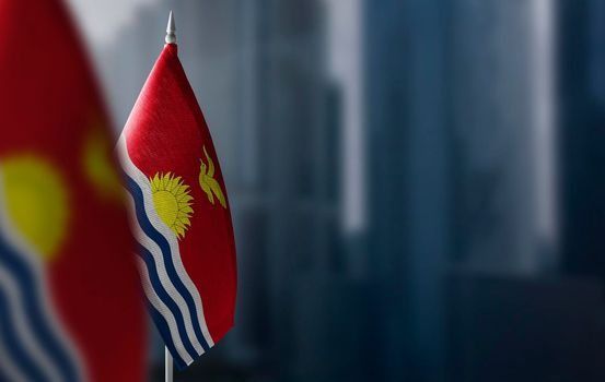 Small flags of Kiribati on a blurry background of the city.