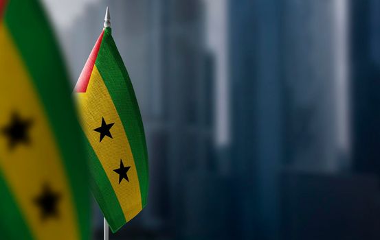 Small flags of Sao Tome and Principe on a blurry background of the city.
