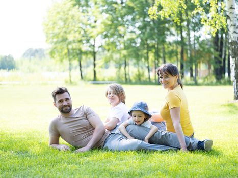 Portrait of happy family enjoying in park on sunny a day