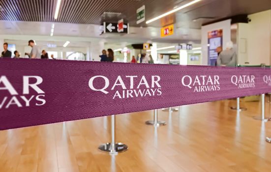 Doha, Qatar, July 2019: Purple ribbon barrier with the Qatar Airways airlines logo