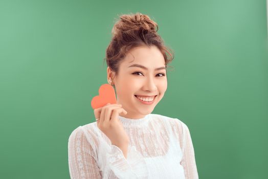 Valentine's Day. Beautiful young woman with heart in her hands.