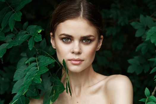beautiful woman skin care bare shoulders green leaves nature Lifestyle. High quality photo
