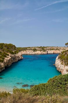 Paradise beach of the mediterranean sea, turquoise water, yes people, cliffs, rocks, white sand, Balearic Islands, Spain