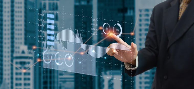 business chart and graph. Businessman touching virtual hologram. business technology concept