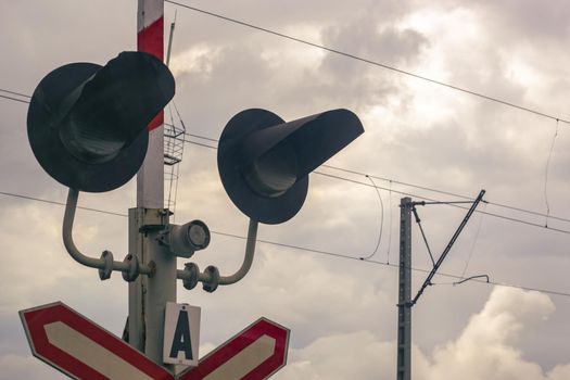 Traffic light at a railway crossing. The object of increased attention is at the intersection of the road and railways.