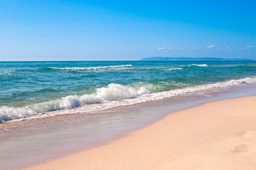 Blue sea with a wave on the sand. Seascape.