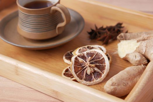 close up of dry lemon, ginger and green tea on table .