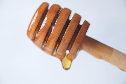 close up of fresh honey with spoon on table .