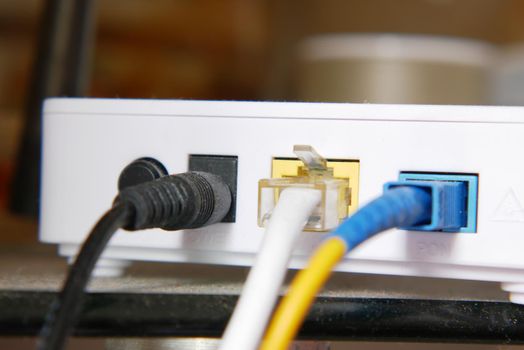 Wi-Fi router with cables on table .