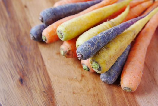 mixed colorful carrot on a chopping board .