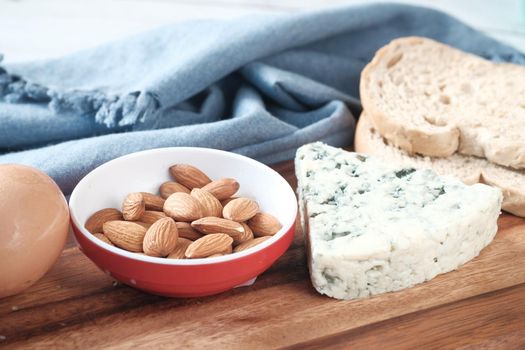 Close up of cheese and almond nut on table