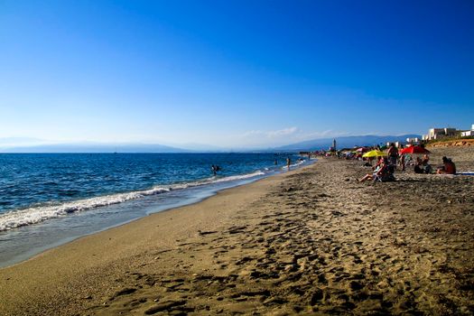 Salinas, Cabo de Gata, Almeria, Spain- September 4, 2021: People enjoying in the Morning on the Salinas beach in Cabo de Gata, Almeria, Spain
