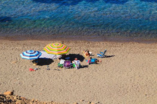 Cabo de Gata, Almeria, Spain- September 3, 2021:People enjoying and sunbathing at the Beautiful Corralete beach on a sunny day of summer