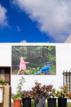 Rodalquilar, Almeria, Spain- September 3, 2021: Whitewashed houses with nice pictures on the wall in Rodalquilar, Andalusia, Spain