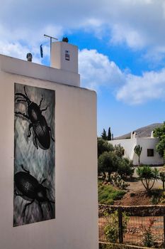 Rodalquilar, Almeria, Spain- September 3, 2021: Whitewashed houses with nice pictures on the wall in Rodalquilar, Andalusia, Spain