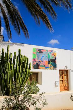 Rodalquilar, Almeria, Spain- September 3, 2021: Whitewashed houses with nice pictures on the wall in Rodalquilar, Andalusia, Spain