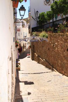 Mojacar, Almeria, Spain- September 8, 2021: Narrow streets with Whitewashed houses in Mojacar village on a sunny day of summer.