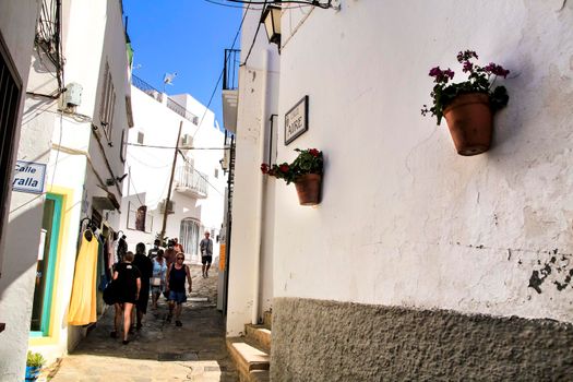 Mojacar, Almeria, Spain- September 8, 2021: Narrow streets with Whitewashed houses in Mojacar village on a sunny day of summer.