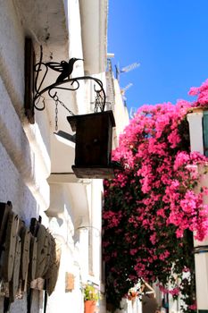 Mojacar, Almeria, Spain- September 8, 2021: Narrow streets with Whitewashed houses in Mojacar village on a sunny day of summer.