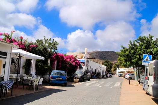 Rodalquilar, Almeria, Spain- September 3, 2021:Whitewashed houses with bougainvillea in Rodalquilar, Andalusia, Spain