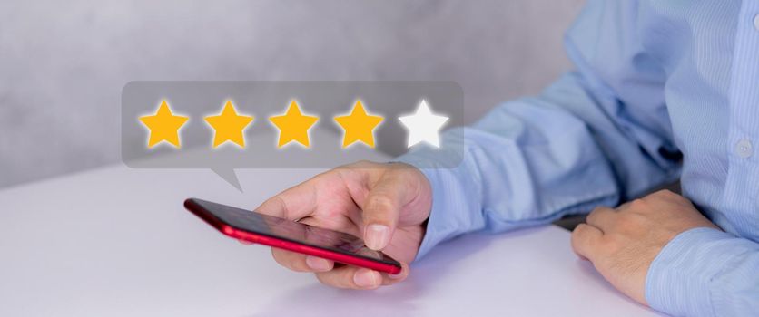 Customer holding phone and pressing star icon for vote score review and feedback with quality and satisfaction, success of digital marketing with result excellent for ranking of service.