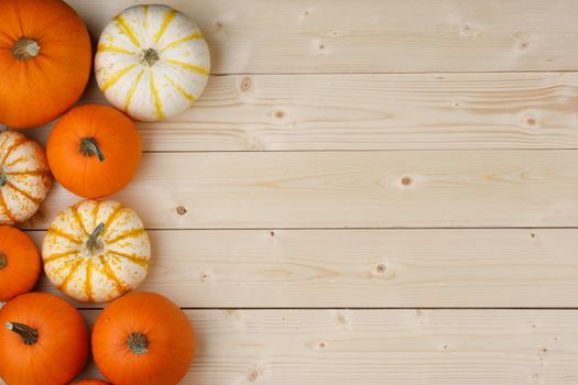 Many pumpkin top border over a rustic wood background