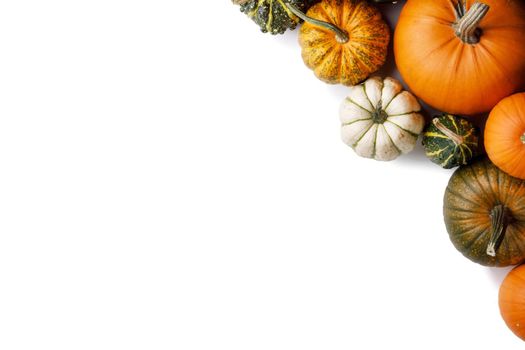 Many colorful pumpkins frame isolated on white background, autumn harvest, Halloween or Thanksgiving concept