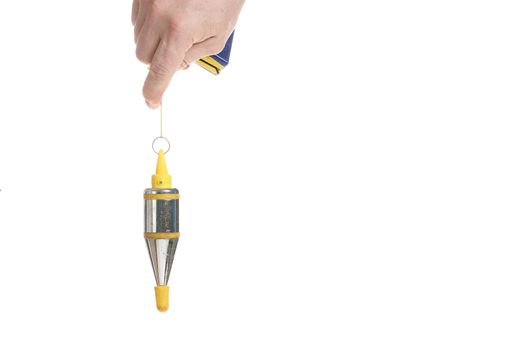Hand holds a metal plumb line on a cord on a white background, a template for designers.