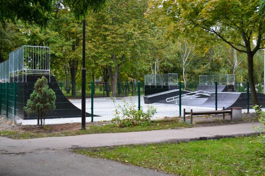 skatepark ramps in the park on autumn. High quality photo