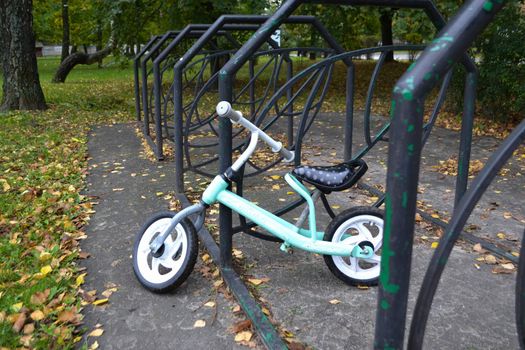 children's bike in the autumn park in the bicycle parking lot. High quality photo