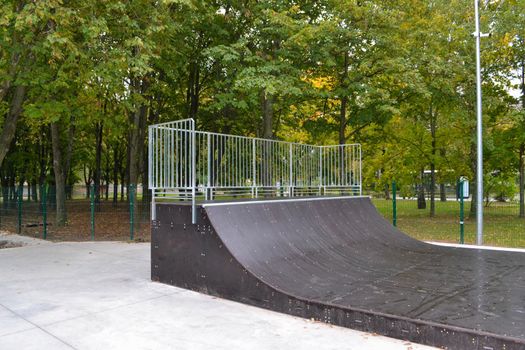 skatepark ramps in the park on autumn. High quality photo