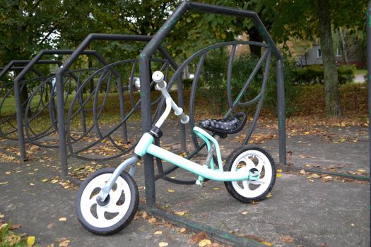 children's bike in the autumn park in the bicycle parking lot. High quality photo